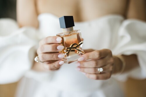 Matias Ezcurra Photography, Bride's hands holding Yves Saint Laurent perfume bottle.