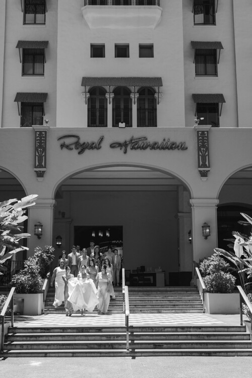 Matias Ezcurra Photography, Bride and wedding party descend Royal Hawaiian Hotel steps.
