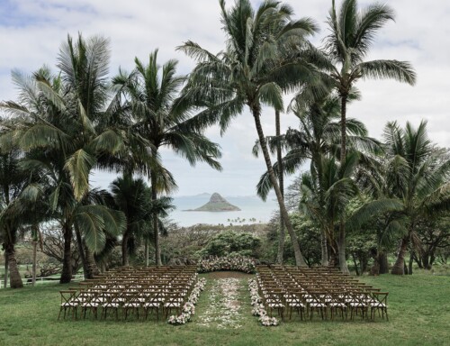 Matias Ezcurra Photography, Outdoor Kualoa Ranch wedding ceremony with floral aisle and ocean view.