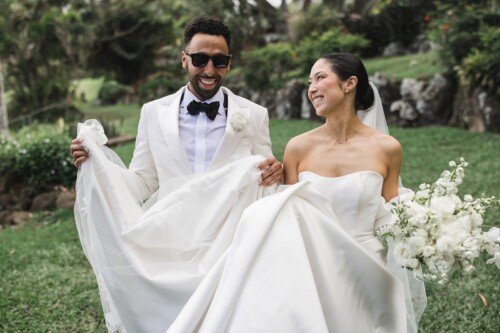 Matias Ezcurra Photography, Happy couple, Klaire & Alex, at their Kualoa Ranch wedding. The bride's dress flows beautifully.