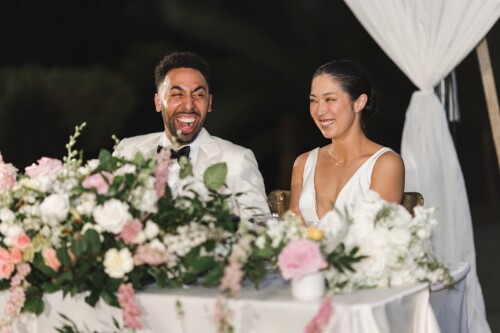 Matias Ezcurra Photography, Happy newlyweds, Klaire & Alex, laugh during their Kualoa Ranch wedding reception.