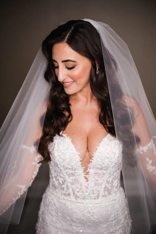 Matias Ezcurra Photography, Bride in a fitted lace wedding dress with long sleeves and veil