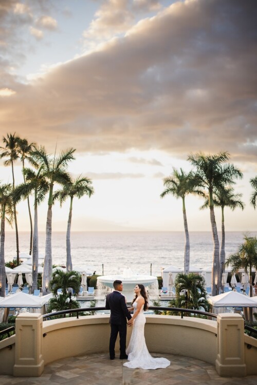 Matias Ezcurra Photography, Bride and groom holding hands, overlooking ocean at sunset