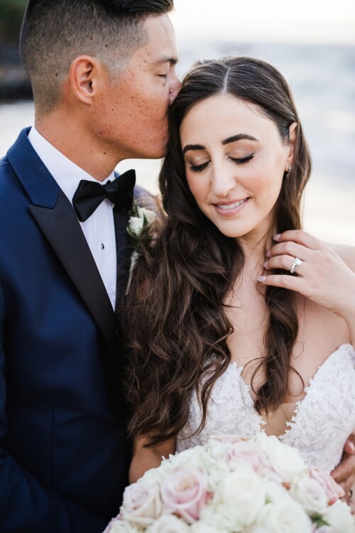 Matias Ezcurra Photography, Groom kisses bride's forehead at beach wedding