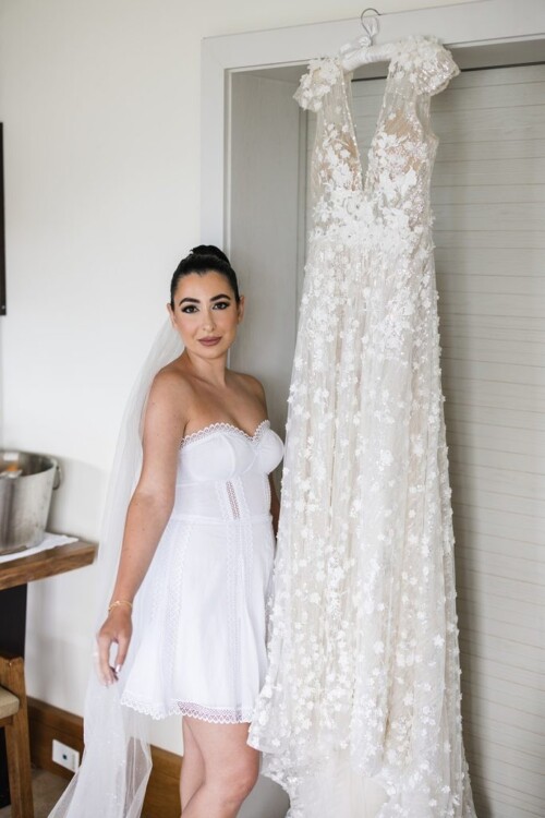 Matias Ezcurra Photography, Bride in white dress next to her wedding gown at Andaz Maui wedding