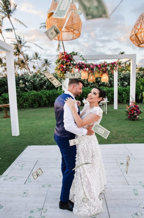 Matias Ezcurra Photography, Happy couple dancing at their Andaz Maui wedding, money falling around them.